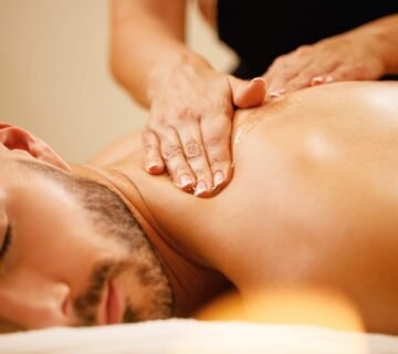 Closeup man enjoying relaxing back massage with honey spa scaled e1686860970475 360x320