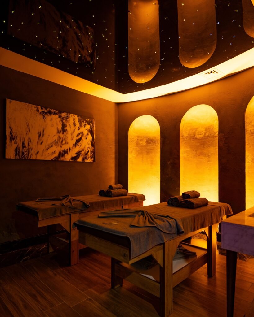 Relaxing spa interior with ambient lighting in Bodrum, Türkiye, showcasing massage tables and decor.